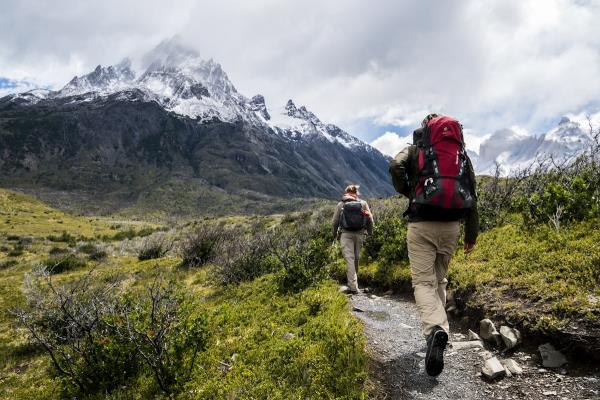 Hiker with a backpack on a wooded trail